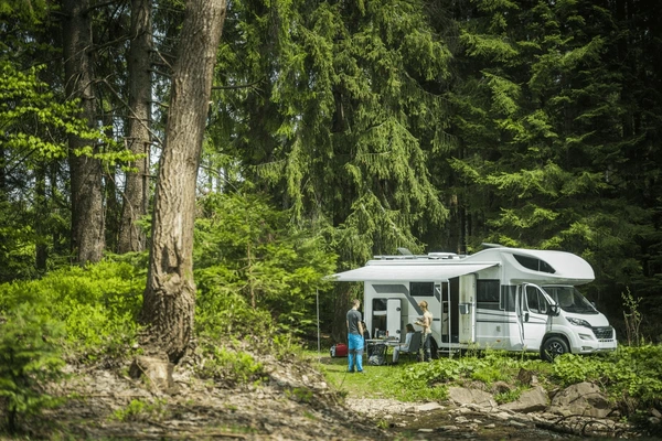 friends-standing-front-parked-camper-600nw-2466094801